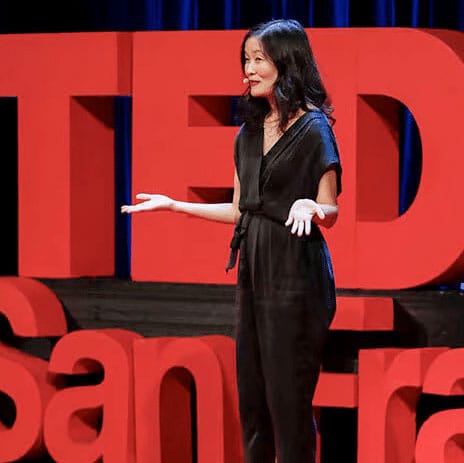 Laura Shin speaking on a TEDx stage, from the official Unchained team page.